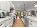 Gourmet kitchen features a gas range, stylish backsplash, stainless steel appliances, and a center island at 1160 S Kings Dr, Charlotte, NC 28207