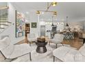 Open-concept living room featuring modern decor, plush seating, and a seamless flow to the kitchen at 1160 S Kings Dr, Charlotte, NC 28207