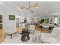 Spacious living room open to kitchen boasts stylish lighting and contemporary furnishings at 1160 S Kings Dr, Charlotte, NC 28207