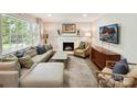 Cozy living room with a fireplace, plush seating, and abundant natural light at 1638 Wensley Dr, Charlotte, NC 28210
