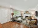 Bright living room featuring hardwood floors, fireplace and large windows at 1638 Wensley Dr, Charlotte, NC 28210