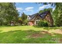 Exterior view of the property showing its beautiful brickwork, large yard, and well-manicured landscaping at 1750 Trellis Dr, Rock Hill, SC 29732