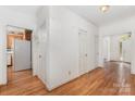 Hallway with hardwood floors, white walls, and multiple doorways leading to other rooms in the home at 1750 Trellis Dr, Rock Hill, SC 29732