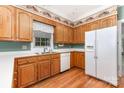 Traditional kitchen with wooden cabinets, white appliances, and a window over the sink at 1750 Trellis Dr, Rock Hill, SC 29732