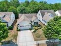 A bird's-eye view of a beautifully landscaped home nestled among mature trees in a quiet neighborhood at 2224 Hartwell Ln, Fort Mill, SC 29707