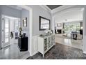 Inviting entryway featuring slate tile floors, decorative mirror, and arched doorway leading into the living area at 2224 Hartwell Ln, Fort Mill, SC 29707