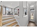 Bright entryway featuring wood stairs, modern railing, and door with sidelights at 3321 Treble Ct, Charlotte, NC 28262
