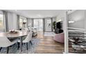 Open living and dining area with hardwood floors and modern furniture at 3321 Treble Ct, Charlotte, NC 28262