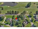 Beautiful aerial view of a home on a golf course with mature trees and a pond at 3506 Cardiff Ln, Matthews, NC 28104