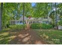 Charming lake house with a screened porch and natural landscaping for a private and peaceful setting at 392 Stonemarker Rd, Mooresville, NC 28117