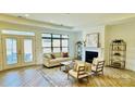Bright living room boasts a fireplace, large windows, and hardwood floors at 409 Newstyle Way, Gastonia, NC 28056