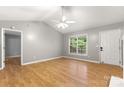 Spacious living room with hardwood floors, a ceiling fan, and a window view at 410 Glass Ct, Kannapolis, NC 28081