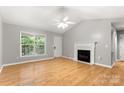 Bright living room with hardwood floors, fireplace, and large window at 410 Glass Ct, Kannapolis, NC 28081