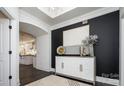 Stylish entryway featuring a decorative console table, dark accent wall, and view into the open-concept living spaces at 411 Newstyle Way, Gastonia, NC 28056