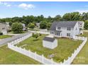 Large backyard with a white picket fence and an outdoor storage shed at 423 Courtland Ct, Kannapolis, NC 28081