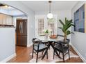 Bright dining area featuring modern lighting, contemporary table, and views to kitchen at 4329 Hathaway St # D, Charlotte, NC 28211