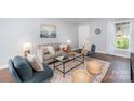 Cozy living room with hardwood floors, neutral colors, and comfortable furniture at 4329 Hathaway St # D, Charlotte, NC 28211