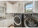 Modern laundry room featuring updated appliances, granite counters, and white cabinets at 5030 Waldron Meadow Dr, Charlotte, NC 28226