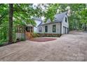 Side exterior of home with white siding, a driveway, and a two-car garage at 5611 Charter Oaks Ln, York, SC 29745