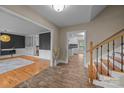 Inviting foyer with hardwood floors and stairs leading to living spaces and kitchen area at 6017 Sierra Dr, Charlotte, NC 28216