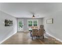 Bright dining area featuring modern light fixture, wood-look floors, a neutral color palette and natural light at 613 Poplar Dr, Shelby, NC 28152