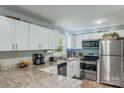 Updated kitchen with stainless steel appliances, granite countertops, and bright white cabinetry at 613 Poplar Dr, Shelby, NC 28152