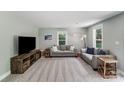 Cozy living room featuring plush carpeting, two neutral sofas, decorative pillows and plenty of natural light at 613 Poplar Dr, Shelby, NC 28152
