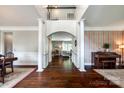 Open-concept living space with hardwood floors, arched doorways, and abundant natural light at 701 Larkridge Ct, Rock Hill, SC 29730
