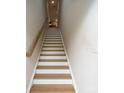 Ascending staircase with modern wood-and-white design and plenty of light at 711 Beaty St, Davidson, NC 28036