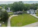 Aerial view of a home with a spacious yard, long driveway, and surrounding trees at 7901 Reames Rd, Charlotte, NC 28216