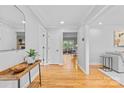 Inviting hallway with hardwood floors, neutral walls, and decorative accents at 7916 Wellston Dr, Charlotte, NC 28210