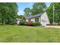Exterior angle view of a home with vinyl siding, attached garage, and well-maintained lawn at 1004 Gracebrook Dr, Salisbury, NC 28147