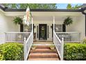 Inviting front porch with brick steps, decorative plants, and a welcoming entrance at 1004 Gracebrook Dr, Salisbury, NC 28147
