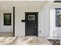 A close-up of the front door showcasing modern design, a sidelight window, and white siding at 1016 Confederate S Ave, Rock Hill, SC 29732