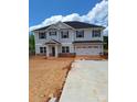 Charming two-story home showcasing a well-manicured lawn and a spacious two-car garage, combining curb appeal with functionality at 115 Kerr Walk Dr # 37, Statesville, NC 28677