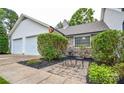 Quaint outdoor patio space with stone accents beside the two-car garage at 1506 Cameron Dr, Statesville, NC 28625