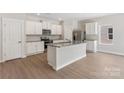 Bright kitchen with stainless steel appliances, granite countertops, and an island with a sink at 1508 Doran Ter, Richburg, SC 29729