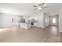 Open floor plan with hardwood floors, a ceiling fan, and a modern kitchen with stainless steel appliances at 1508 Doran Ter, Richburg, SC 29729
