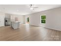 Open floor plan with hardwood floors, a large window, and a sliding glass door that leads to the backyard at 1508 Doran Ter, Richburg, SC 29729