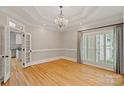 Dining room with tray ceiling, chandelier, and natural light at 17308 Players Ridge Dr, Cornelius, NC 28031