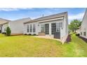 Well-maintained backyard featuring a patio, lush lawn, and mature landscaping at 17436 Hawks View Dr, Indian Land, SC 29707