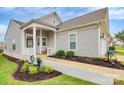 Charming home featuring a covered front porch, manicured lawn, and inviting curb appeal at 17436 Hawks View Dr, Indian Land, SC 29707