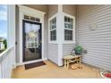 Inviting covered front porch with stylish decor and cozy bench seating at 17436 Hawks View Dr, Indian Land, SC 29707