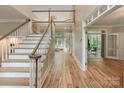 Bright foyer boasting a grand staircase, wood floors, and an open layout leading to various living spaces at 2006 Sandy Pond Ln, Waxhaw, NC 28173