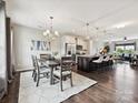 Open concept living and dining area with hardwood floors, modern lighting, and stylish decor at 2017 New Hope Branch Way, Belmont, NC 28012
