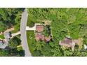 Aerial view showcasing the property's location in a lush, tree-filled neighborhood with nearby road access at 2234 Hamilton Mill Rd, Charlotte, NC 28270