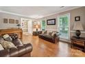Well-lit living room with hardwood floors, comfortable seating, and a view into the home at 2234 Hamilton Mill Rd, Charlotte, NC 28270
