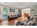 Inviting living room featuring hardwood floors, natural light, and comfortable leather seating area at 2234 Hamilton Mill Rd, Charlotte, NC 28270
