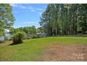 Expansive backyard with lush green grass leading to the waterfront at 2563 Brawley School Rd, Mooresville, NC 28117