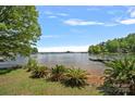 Beautiful waterfront property showcasing serene lake views and lush landscaping at 2563 Brawley School Rd, Mooresville, NC 28117